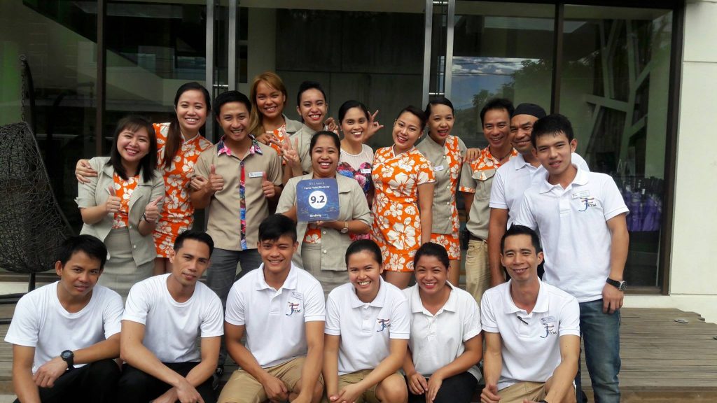 Ferra Hotel Staff photographed with their Booking.com 9.2 Guest Review Award