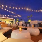 Ferra Hotel Boracay rooftop restaurant, with soft seating and glossy white tables, light by fairy lights