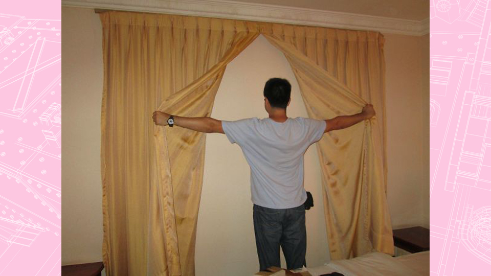 Man in a hotel room opening curtains to reveal the room wall. Article Hotel Design Faults by MY RANGGO Hospitality Magazine