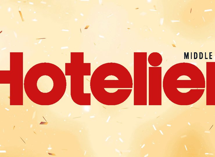Logo for the online publication Hotelier Middle East, cream background with Hotelier Text in Red