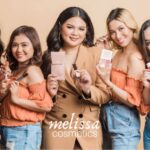 Line of Filipino women holding cosmetic products by Melissa Cosmetics. Article 10 Hotelier owned businesses to support by MY RANGGO Hospitality Magazine