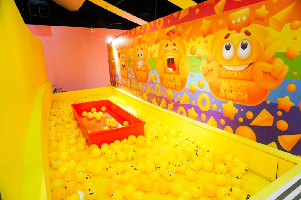Photo of a brightly painted ball pool, with yellow balls which have faces at Museum of Emotions - Article Things to do in Cebu by MY RANGGO Hospitality Magazine Philippines 